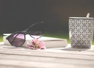 book with sunglasses and cup of tea