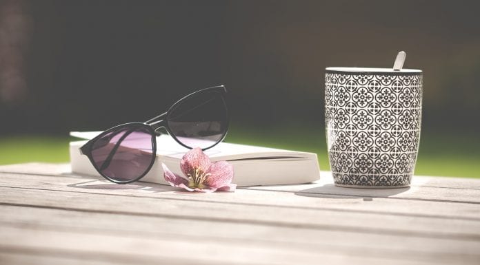 book with sunglasses and cup of tea