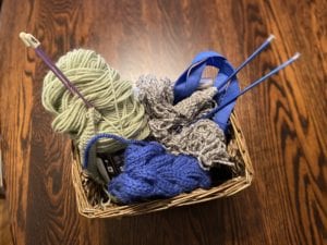 basket of yarn and knitting needles 