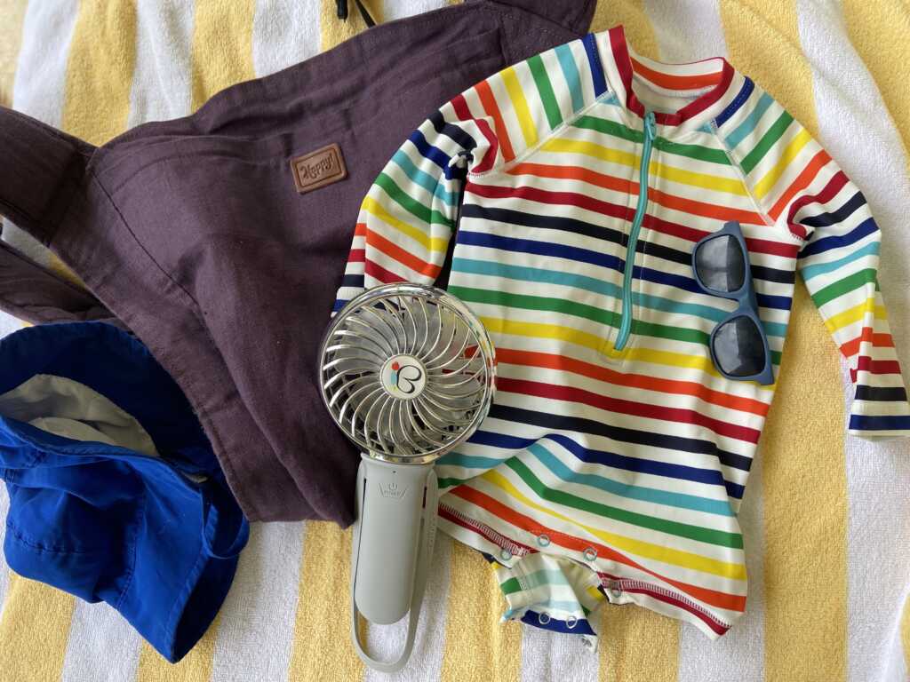 5 Items For A Successful Beach Trip With A Newborn, rash guard, sunblock, baby carrier, portable fan, baby hat, beach tent