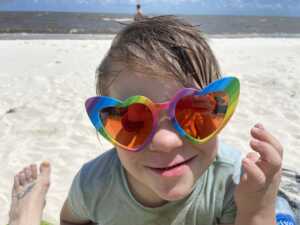 My boy wearing my rainbow sunglasses